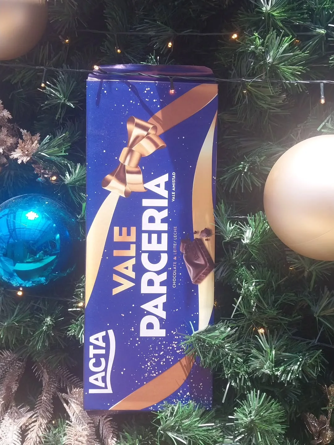 Peça Vale Parceria da campanha de Natal da Lacta pendurada na árvore